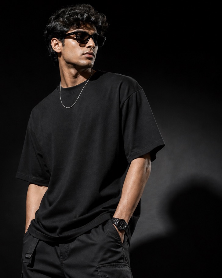 Young Indian man wearing minimal black Urban Yuva streetwear